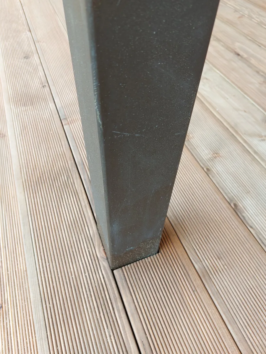 Neatly cut decking fitted around an existing pillar
