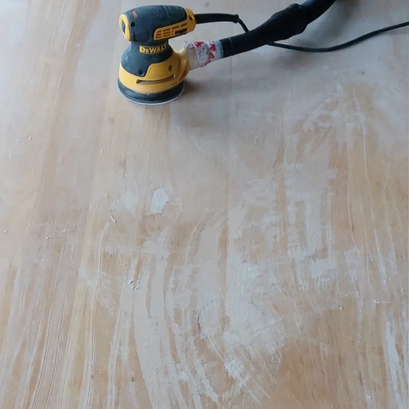Detail of the dining table being sanded