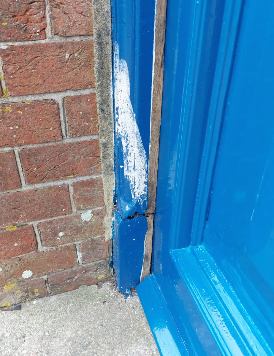 Rotten lower section of entrance door frame upright