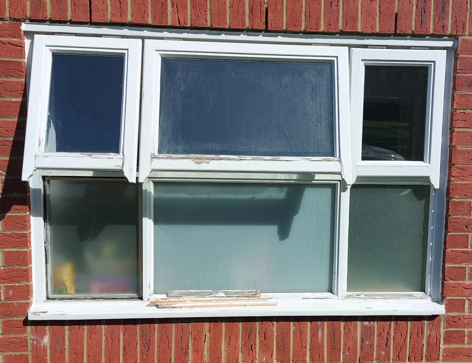 Timber window with deteriorated frame and failed double-glazed units