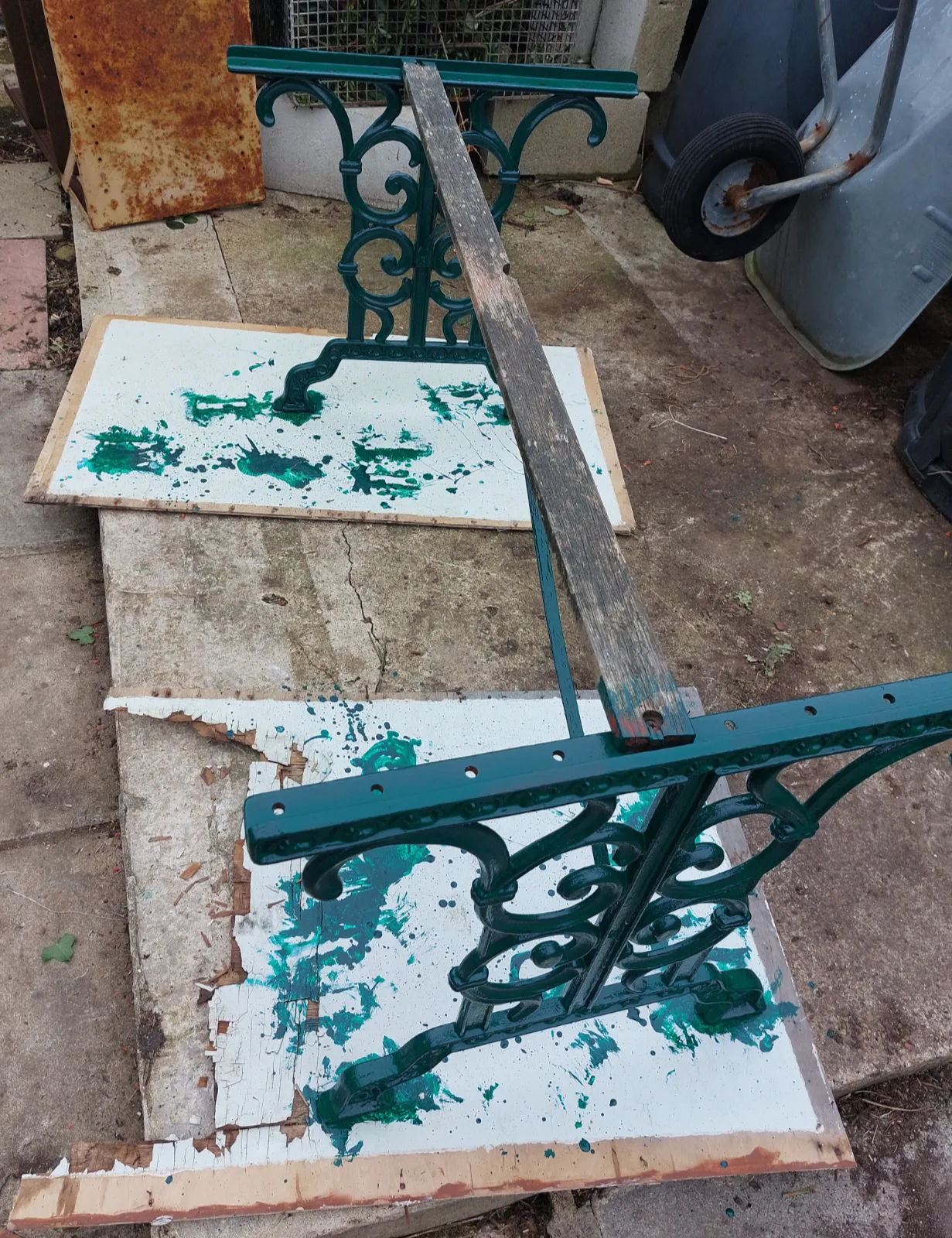 Cast-iron garden furniture being repainted green