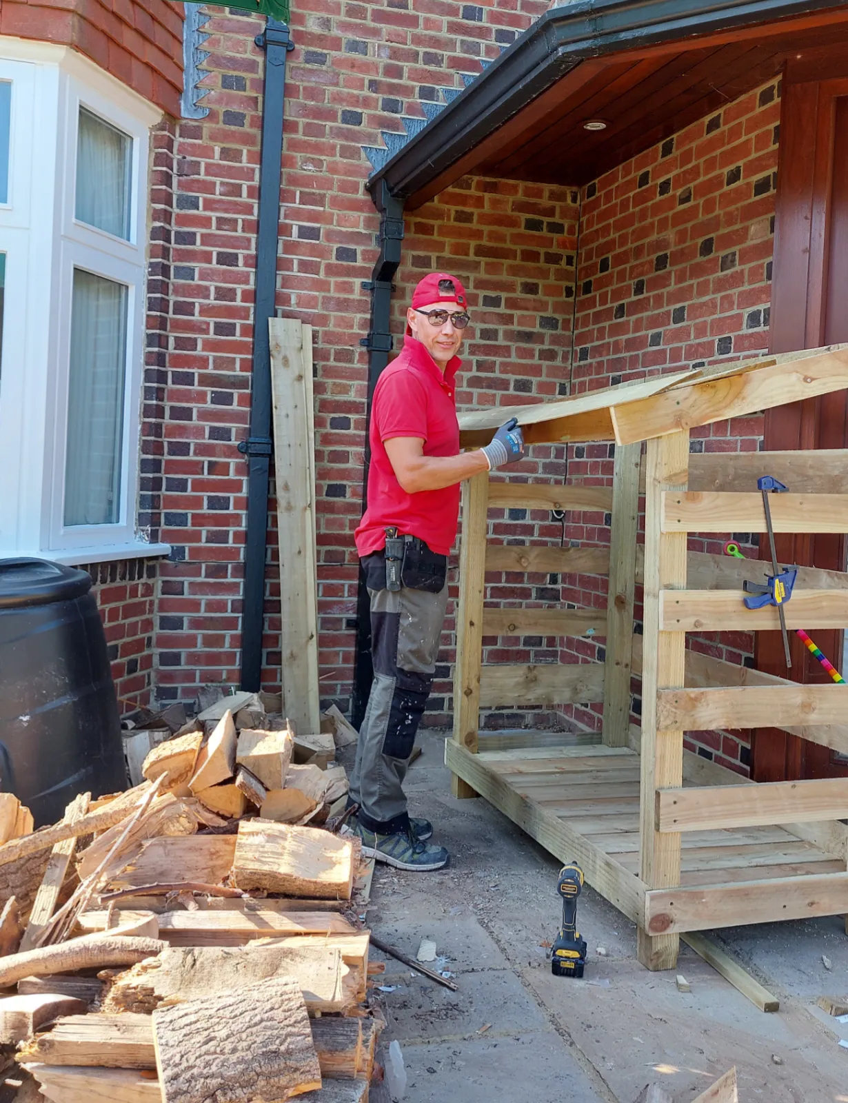 Dmytro constructing the timber log store