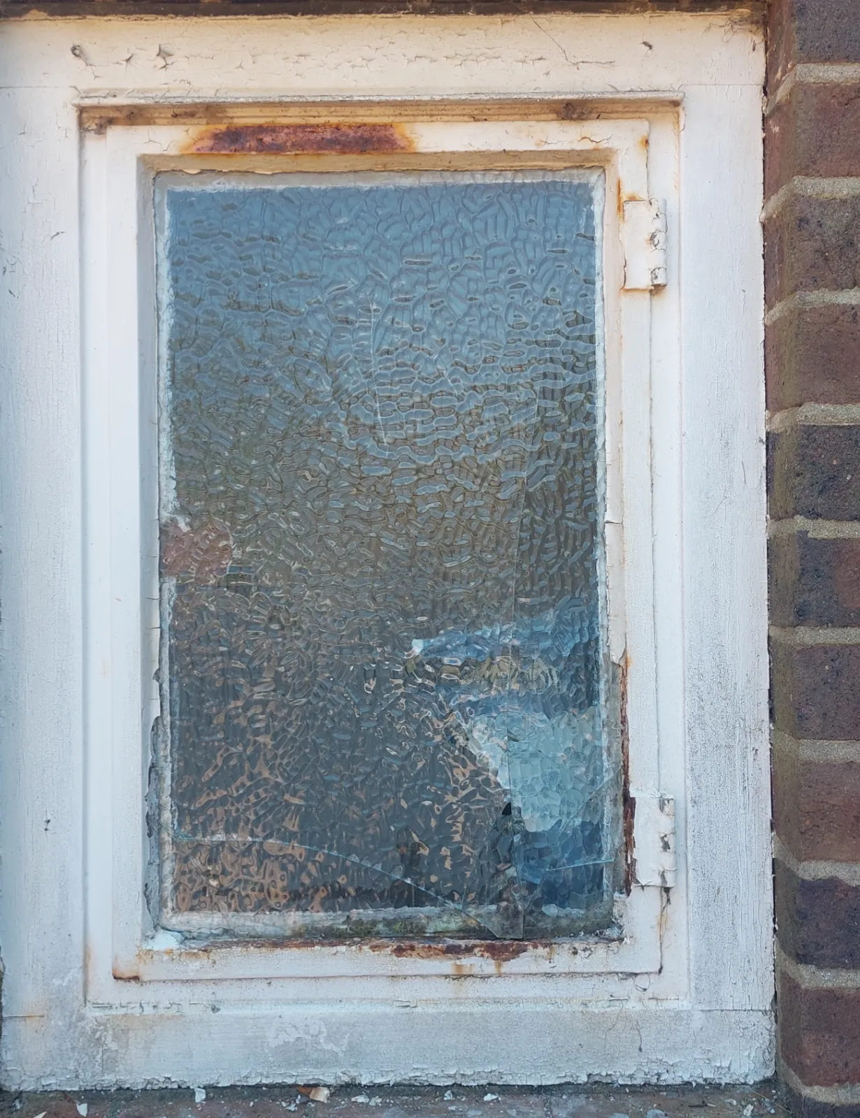 Small exterior metal window before maintenance