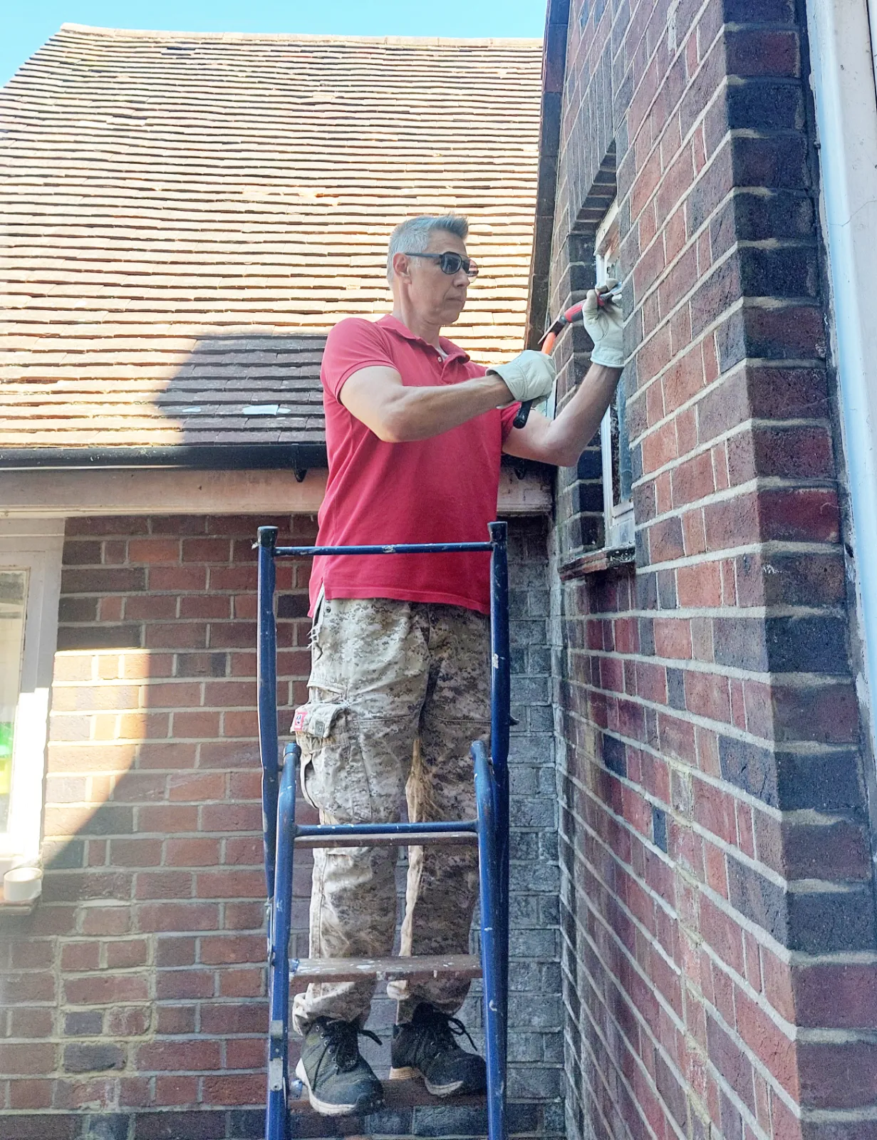 Dmytro working on an exterior metal window